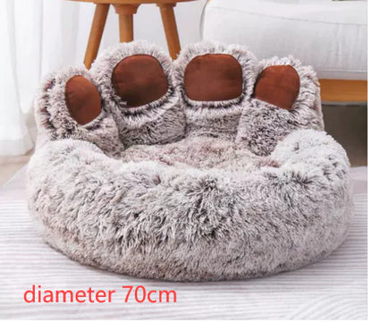 Fluffy pet bed with paw design on a white surface