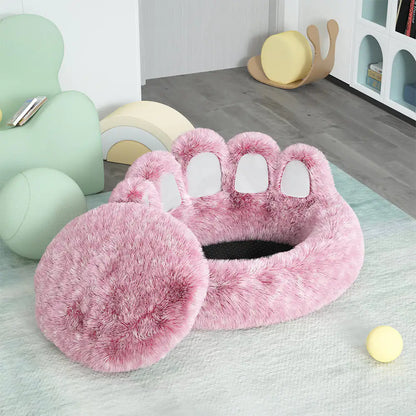 Pink paw-shaped pet bed on a light green rug with colorful chairs in the background.